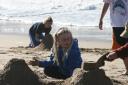 Erin watching the sand castle construction