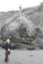 Sara on shore, Jensen and Kent on rock at Pirates Cove